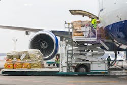 Cargo gets loaded into an airplane Cargo gets loaded into an airplane