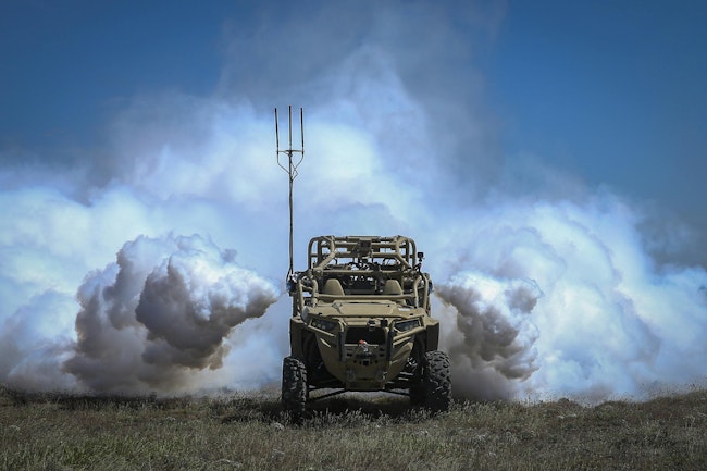 A Screening Obscuration Module attached to a Utility Task Vehicle is activated autonomously during the Robotic Complex Breach Concept on Yakima Training Center in Yakima, Wash. Marine Corps photo.