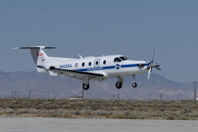 NASA's Pilatus PC-12 prop plane flies above the runway.