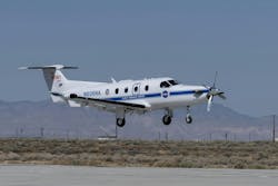 NASA's Pilatus PC-12 prop plane flies above the runway. NASA's Pilatus PC-12 prop plane flies above the runway.