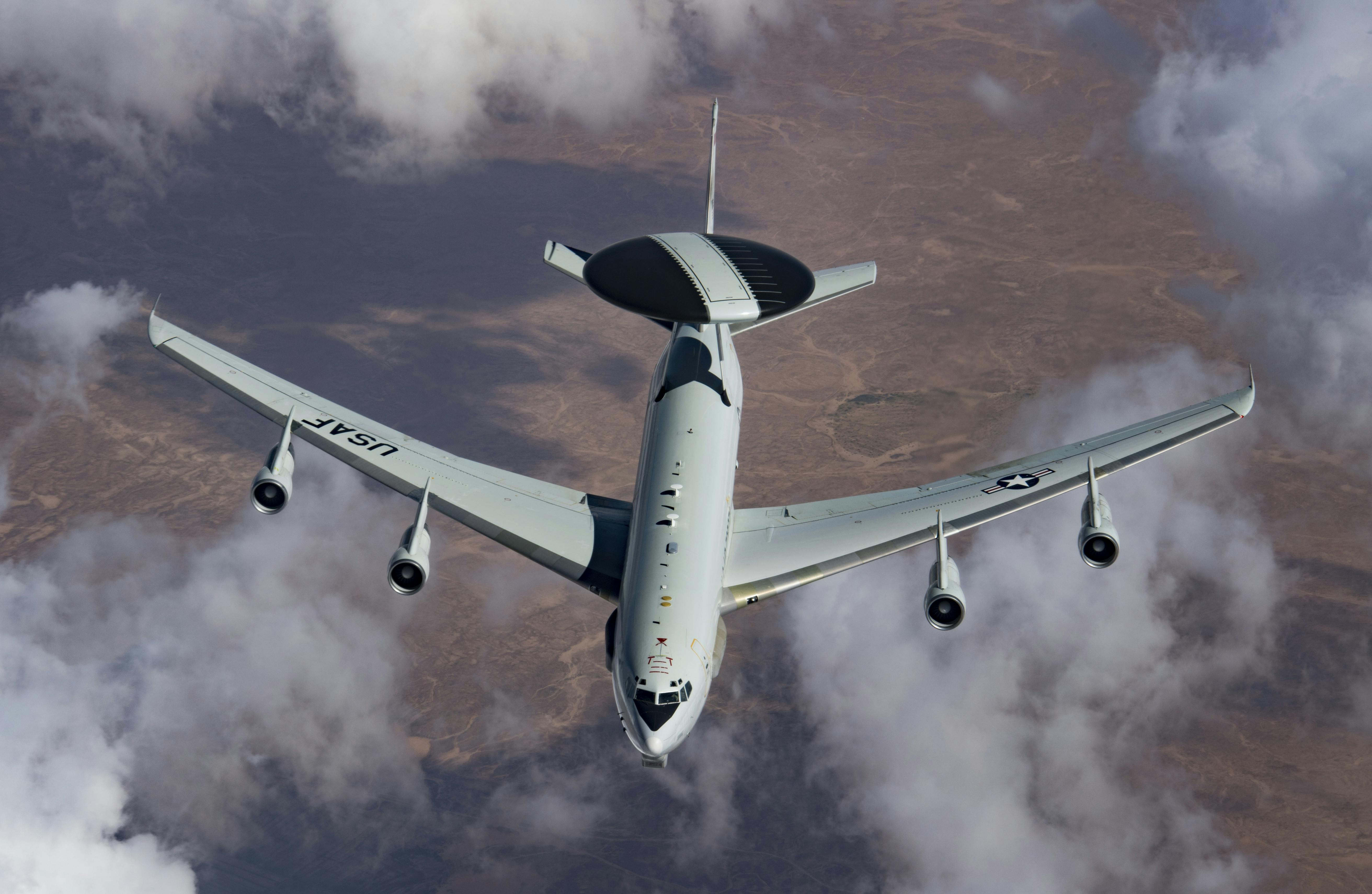 A U.S. Air Force E-3 Sentry breaks away from a KC-135 Stratotanker after being refueled, while flying in support of Operation Inherent Resolve.