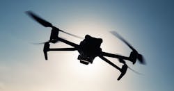 A quadcopter UAV silhouetted against the sun A quadcopter UAV silhouetted against the sun