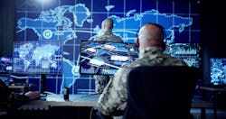 Cyber technology operator monitoring surveillance cameras in military control center. Cyber technology operator monitoring surveillance cameras in military control center.