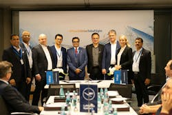 A group photo of businesspeople standing. A group photo of businesspeople standing.