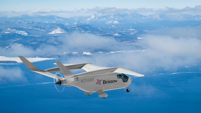 BETA's ALIA aircraft flying over water with mountains in the background.