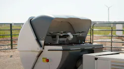 A percepto drone sits in an open container in the field.