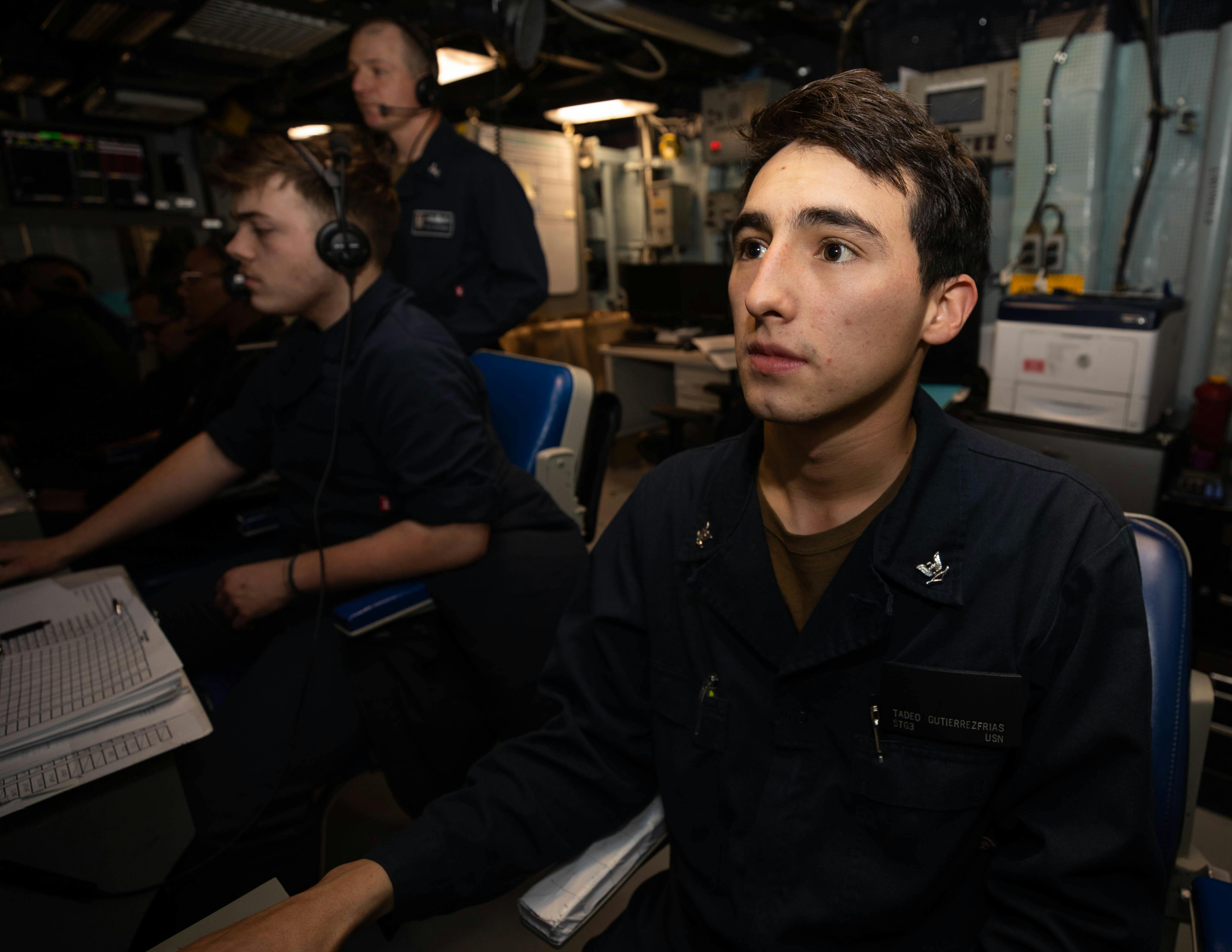 A U.S. Navy surface sonar technician stands watch in the sonar control center aboard the Arleigh Burke-class guided-missile destroyer USS Roosevelt (DDG 80) in the Mediterranean Sea.