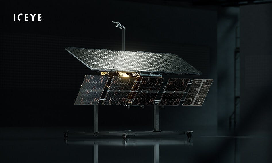 A press release photo of ICEYE's satellite in a darkened room