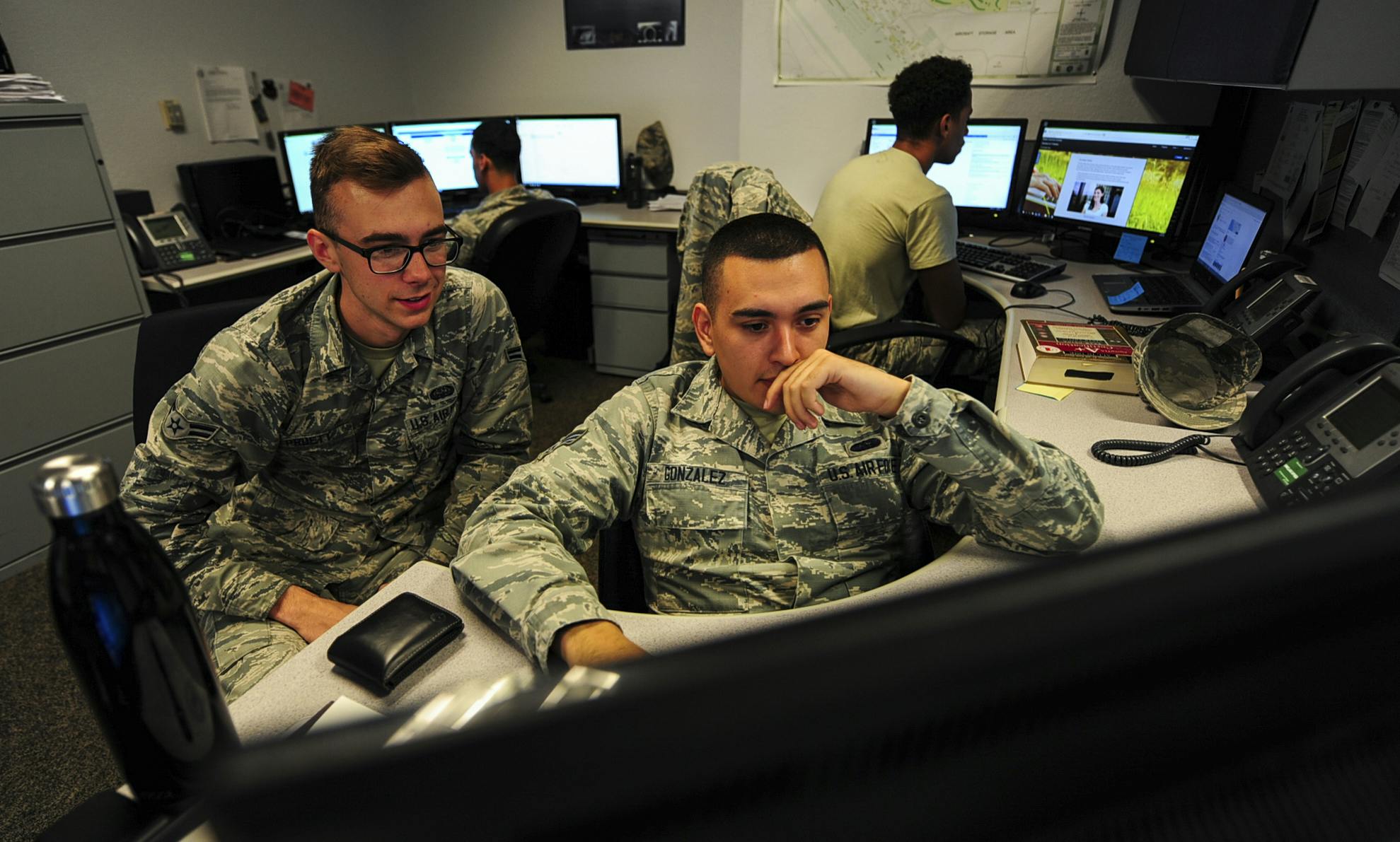 U.S. Air Force cyber security technicians review work orders at Davis-Monthan Air Force Base Ariz., who help safeguard operational and communications security for computer and phone systems.