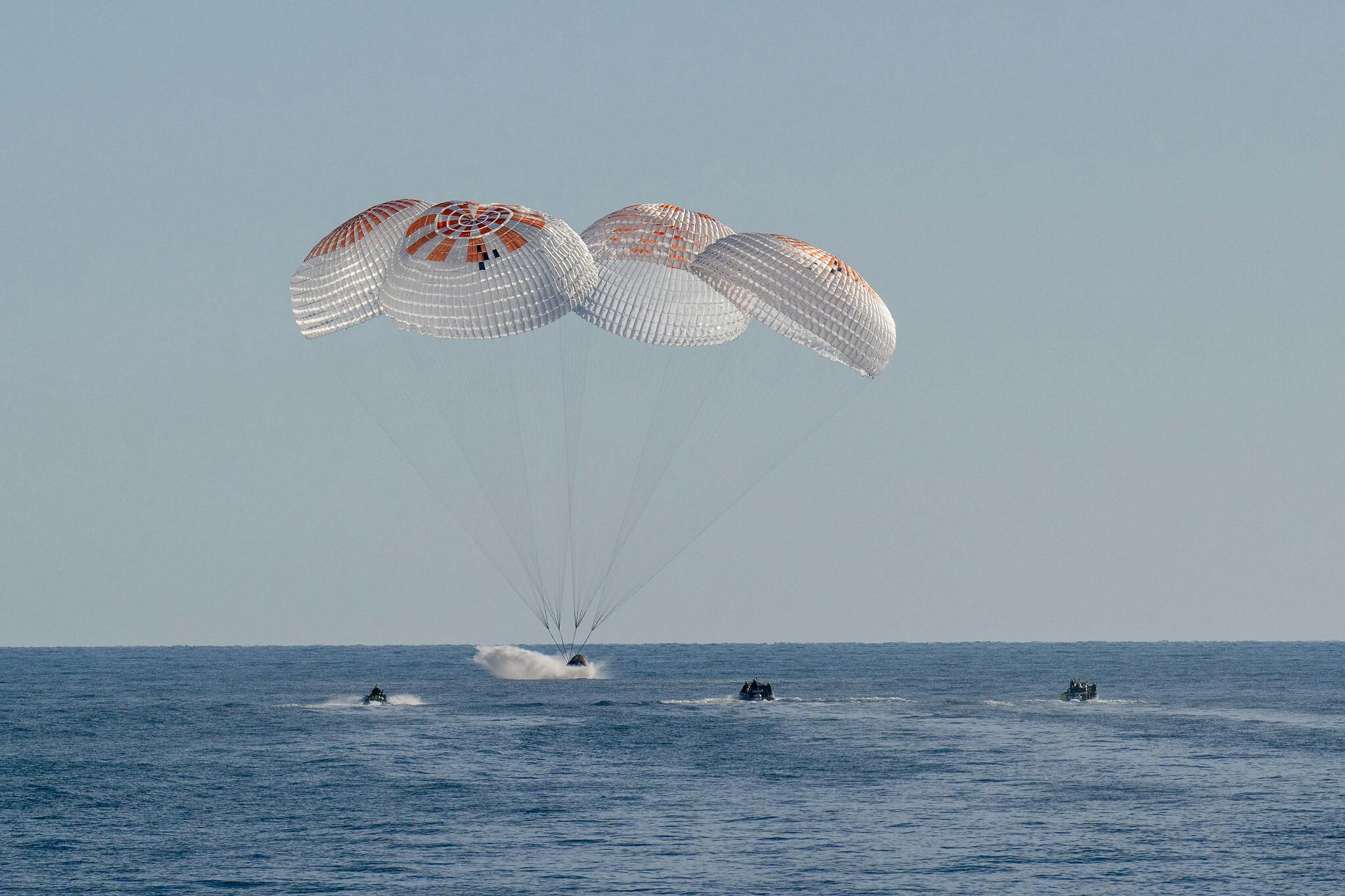 NASA astronauts Nick Hague, Suni Williams, Butch Wilmore, and Roscosmos cosmonaut Aleksandr Gorbunov land in a SpaceX Dragon spacecraft in the water off the coast of Tallahassee, Florida on March 18, 2025. Hague, Gorbunov, Williams, and Wilmore returned from a long-duration science expedition aboard the International Space Station. NASA/Keegan Barber photo.