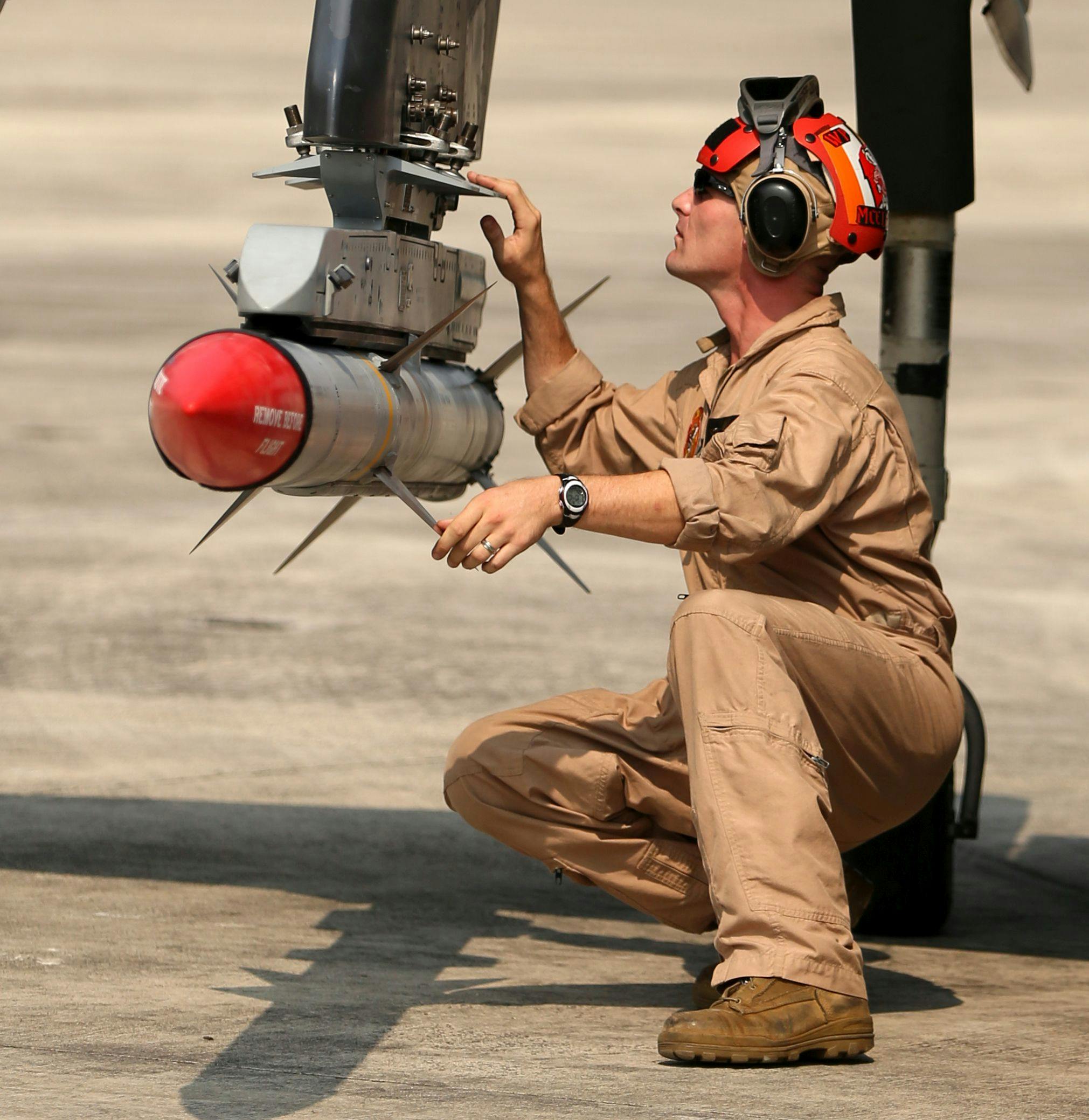 A U.S. Marine Corps ground crewman conducts a pre-flight safety check of an AIM-120A advanced medium-range air-to-air missile at Marine Corps Air Station Cherry Point, N.C.