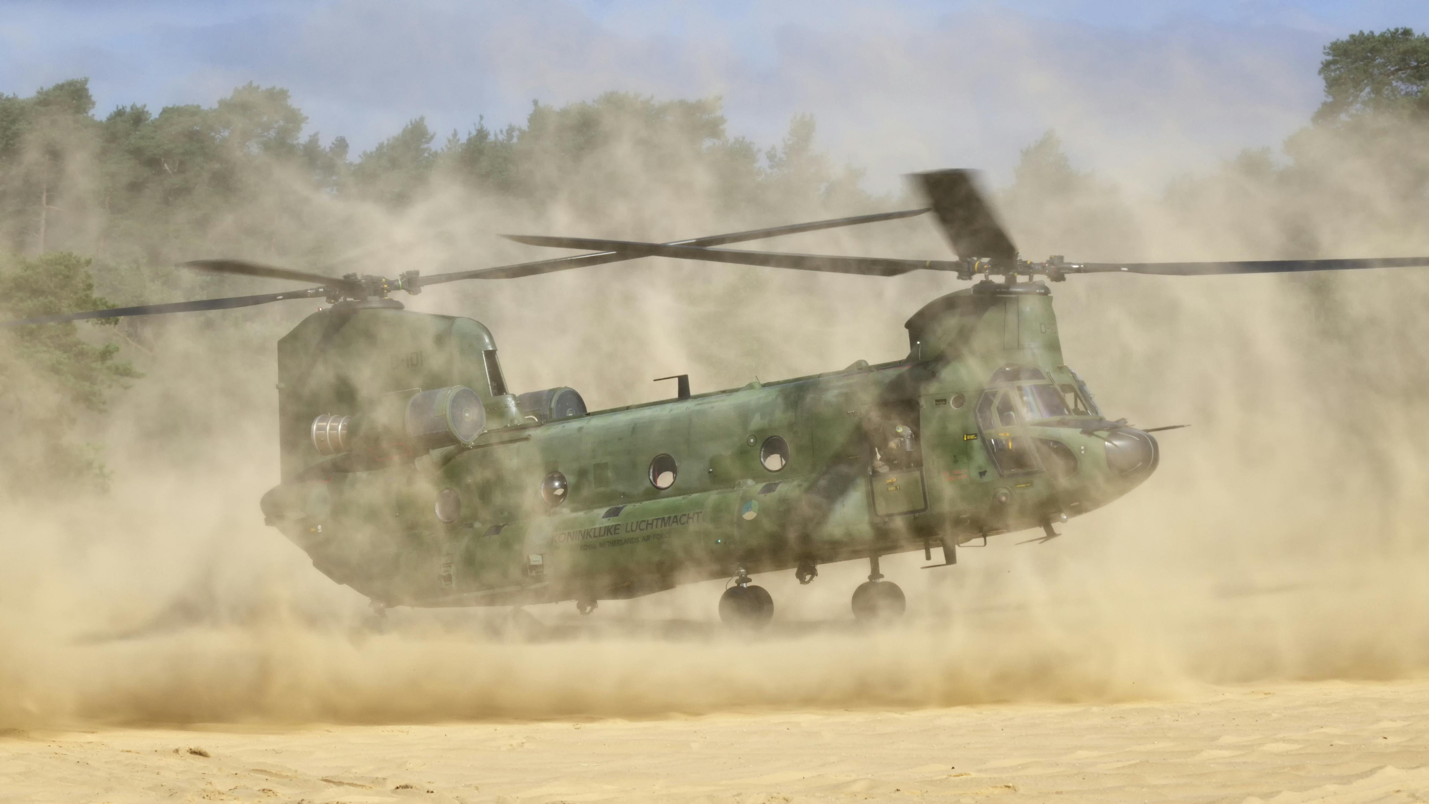 This photo shows Boeing CH-47D Chinook helicopter kicking up dust and creating blinding brownout conditions.