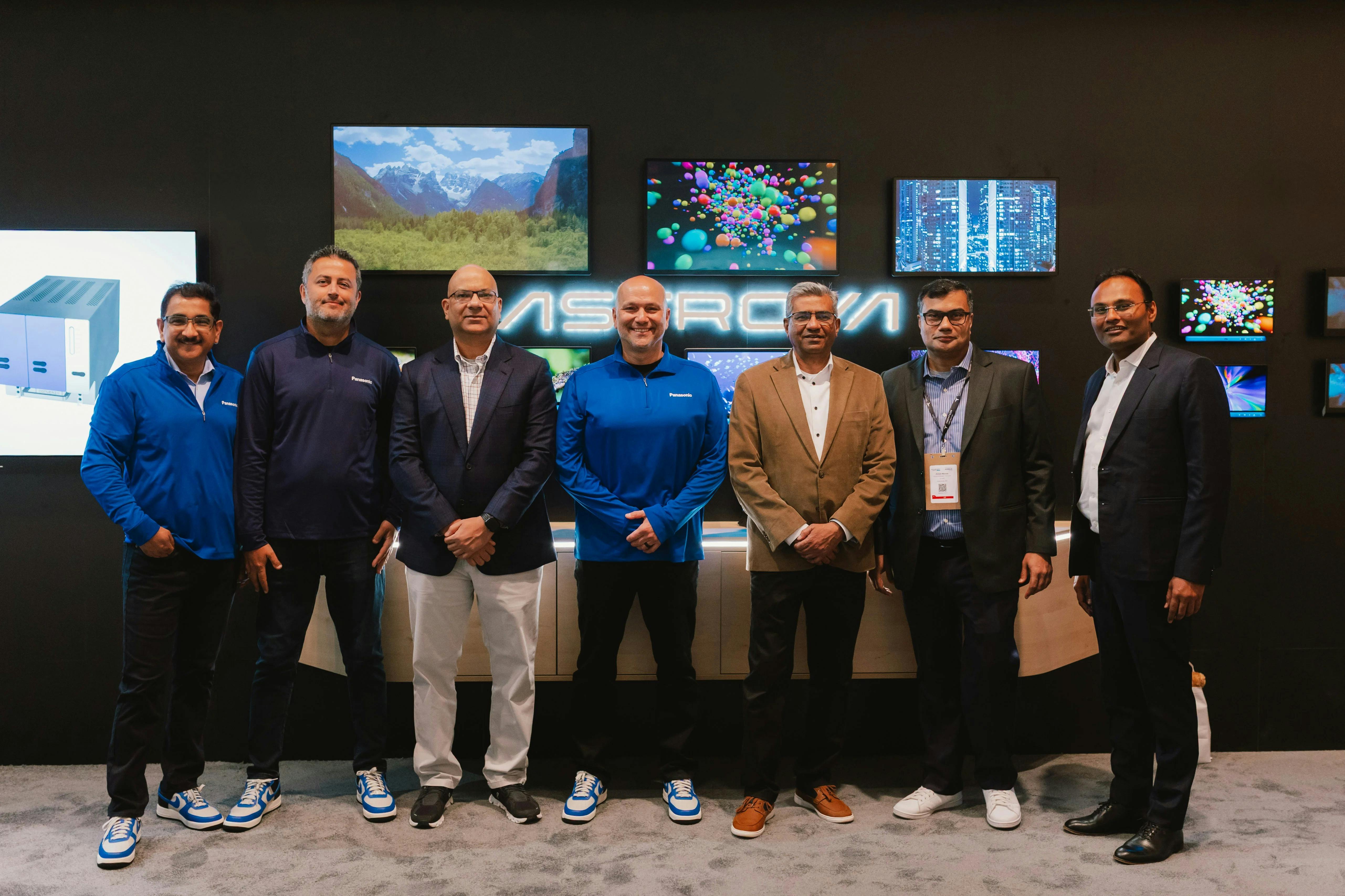 A photo of Air India and Panasonic employees at a trade show booth