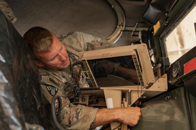 An Army signal support systems specialist installs a Joint Battle Command–Platform (JBC-P) during a communications exercise in Kuwait.