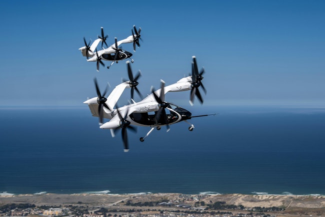 A pair of Joby eVTOL aircraft flying in tandem