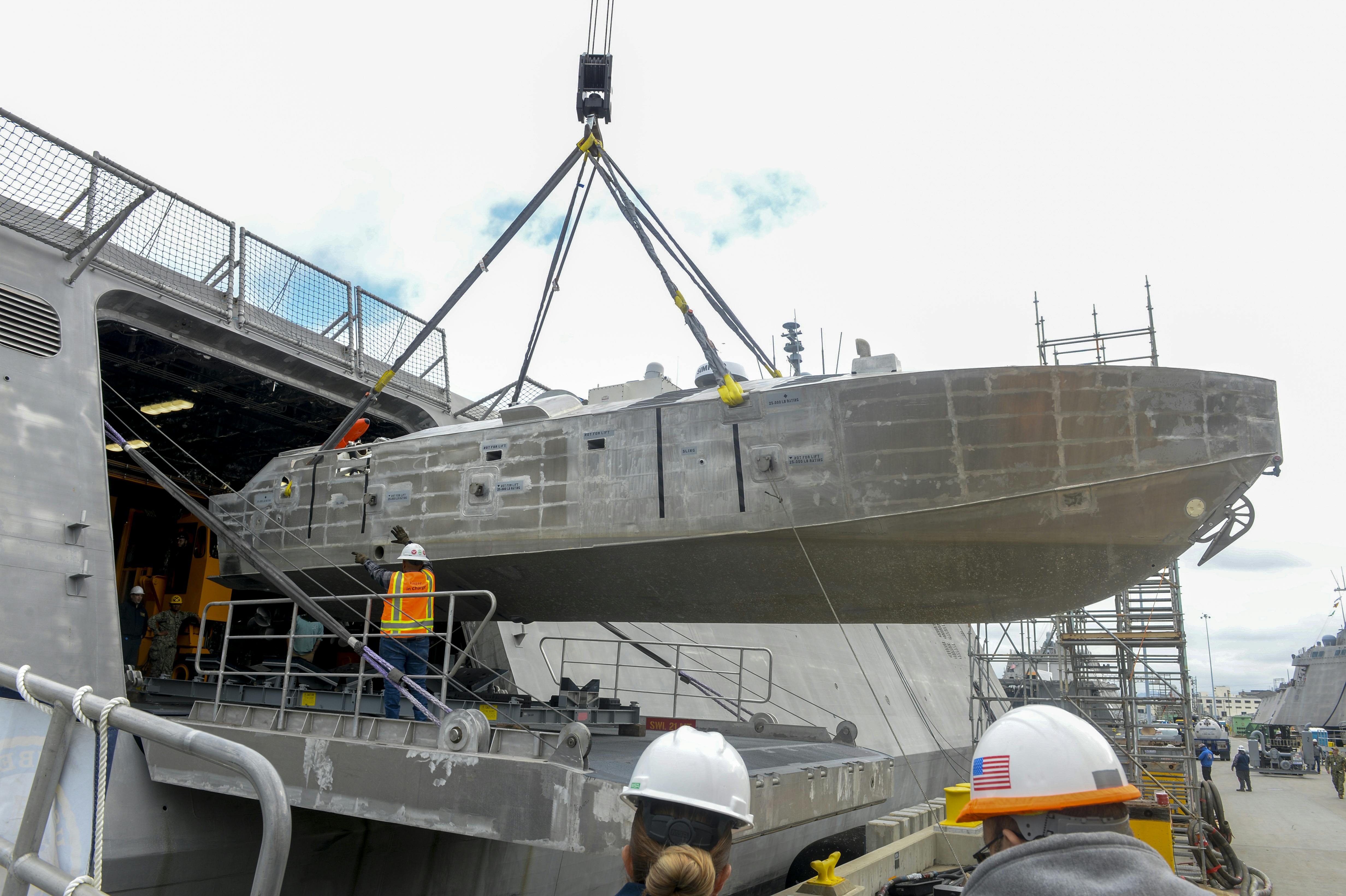 A Mine Countermeasures Unmanned Surface Vessel (MCM-USV) is craned aboard the littoral combat ship USS Canberra (LCS 30) last month. The vessel's counter-mine sensor and weapons payloads help locate, identify, and destroy ocean mines.