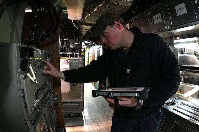 A Navy sonar technician conducts routine electronics inspections aboard the fast-attack submarine USS Virginia (SSN 774) earlier this year.