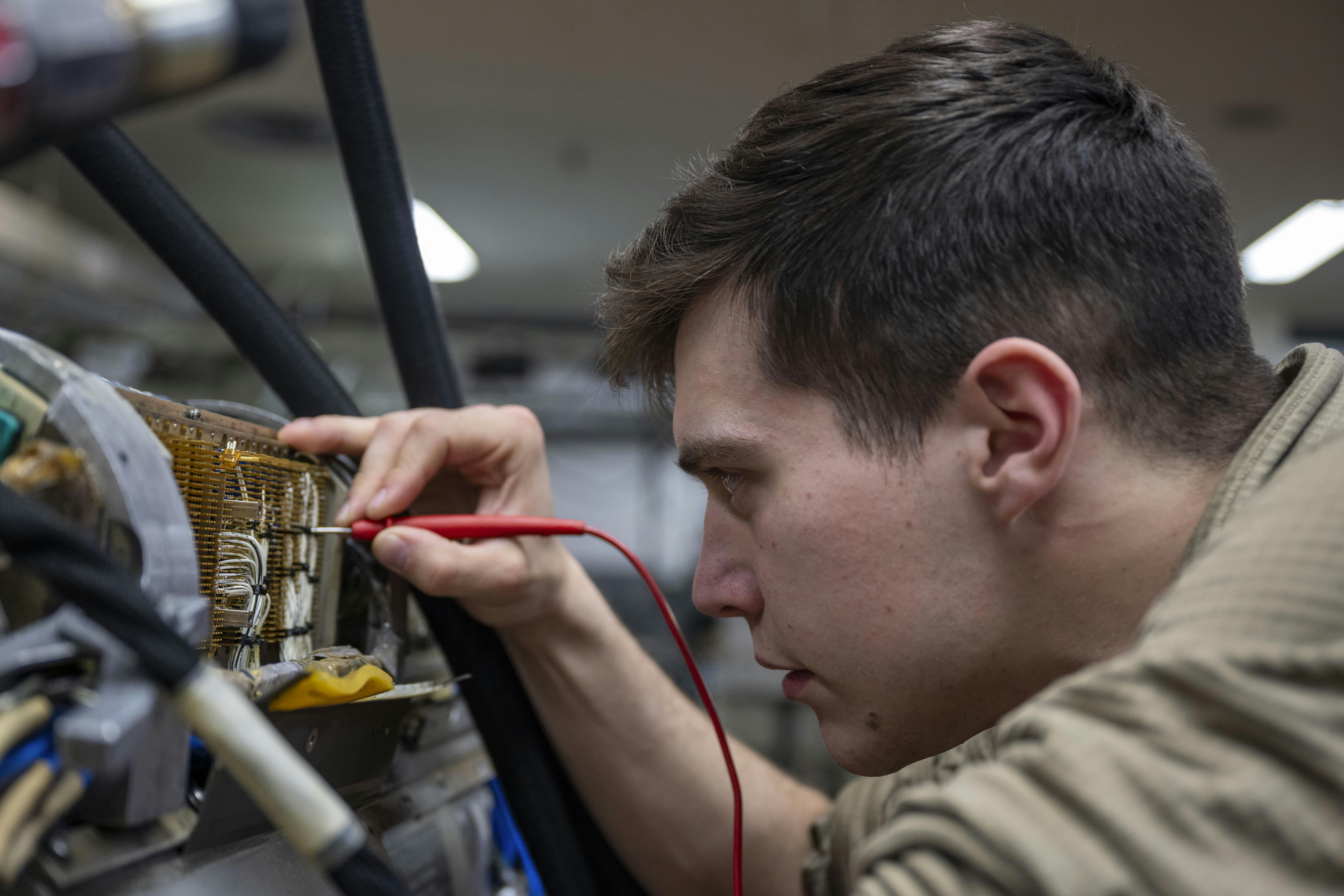 An Air Force electronic warfare systems technician, works on an AN/ALQ-184 electronic countermeasures pod at Misawa Air Base, Japan, last month.