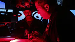 The captain of the destroyer USS Bulkeley (DDG 84) reviews log books during a deployment to support the warfighting effectiveness.