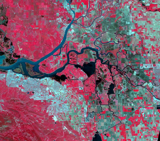 The NASA Advanced Spaceborne Thermal Emission and Reflection Radiometer (ASTER) captured this image of the Sacramento-San Joaquin River Delta, Calif., in which red indicates vegetation, dark blue indicates water, and blue-gray areas indicate buildings and paved surfaces.