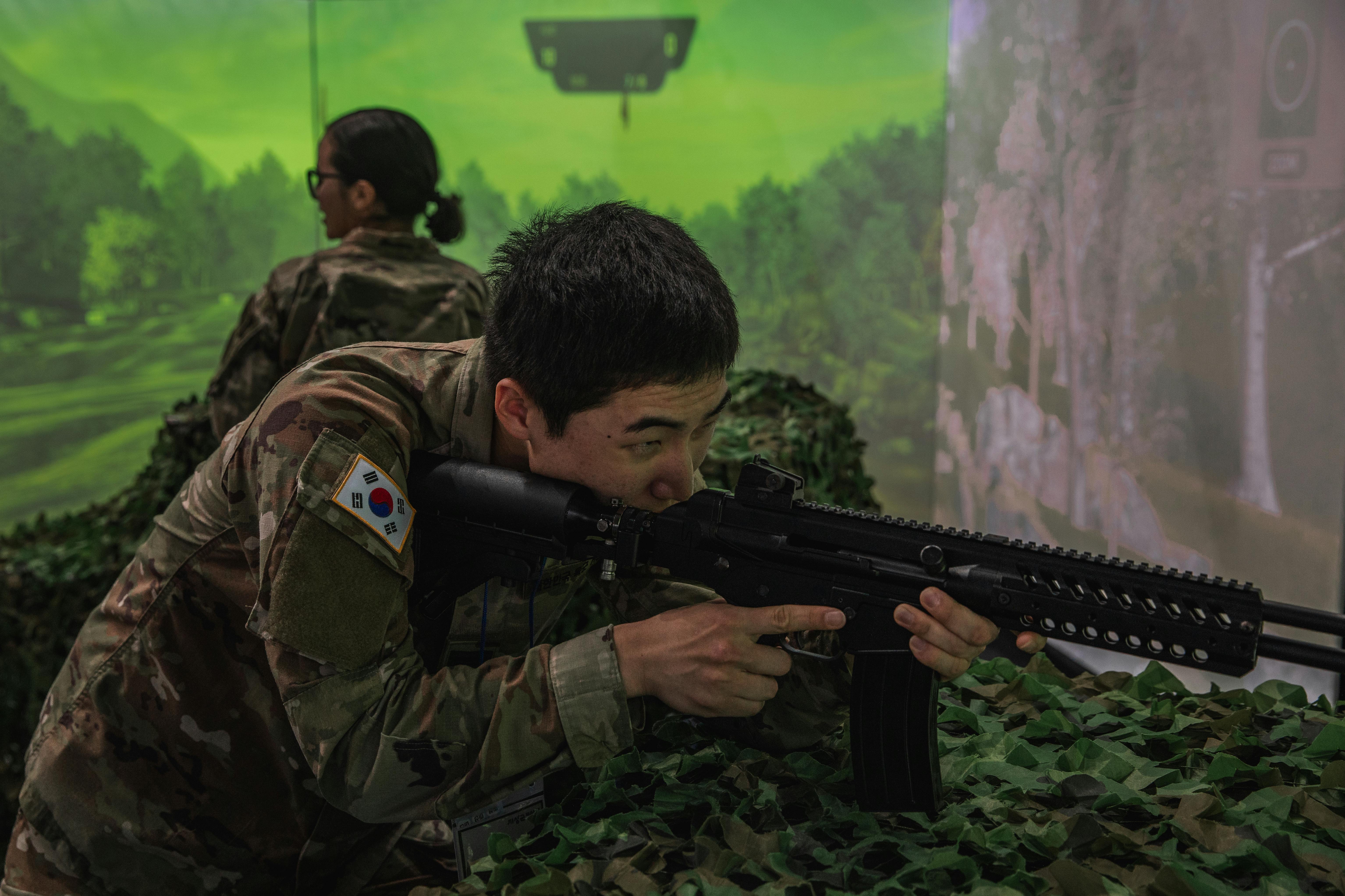 An Army soldier interacts with a Korean weapons simulation in South Korea last fall.