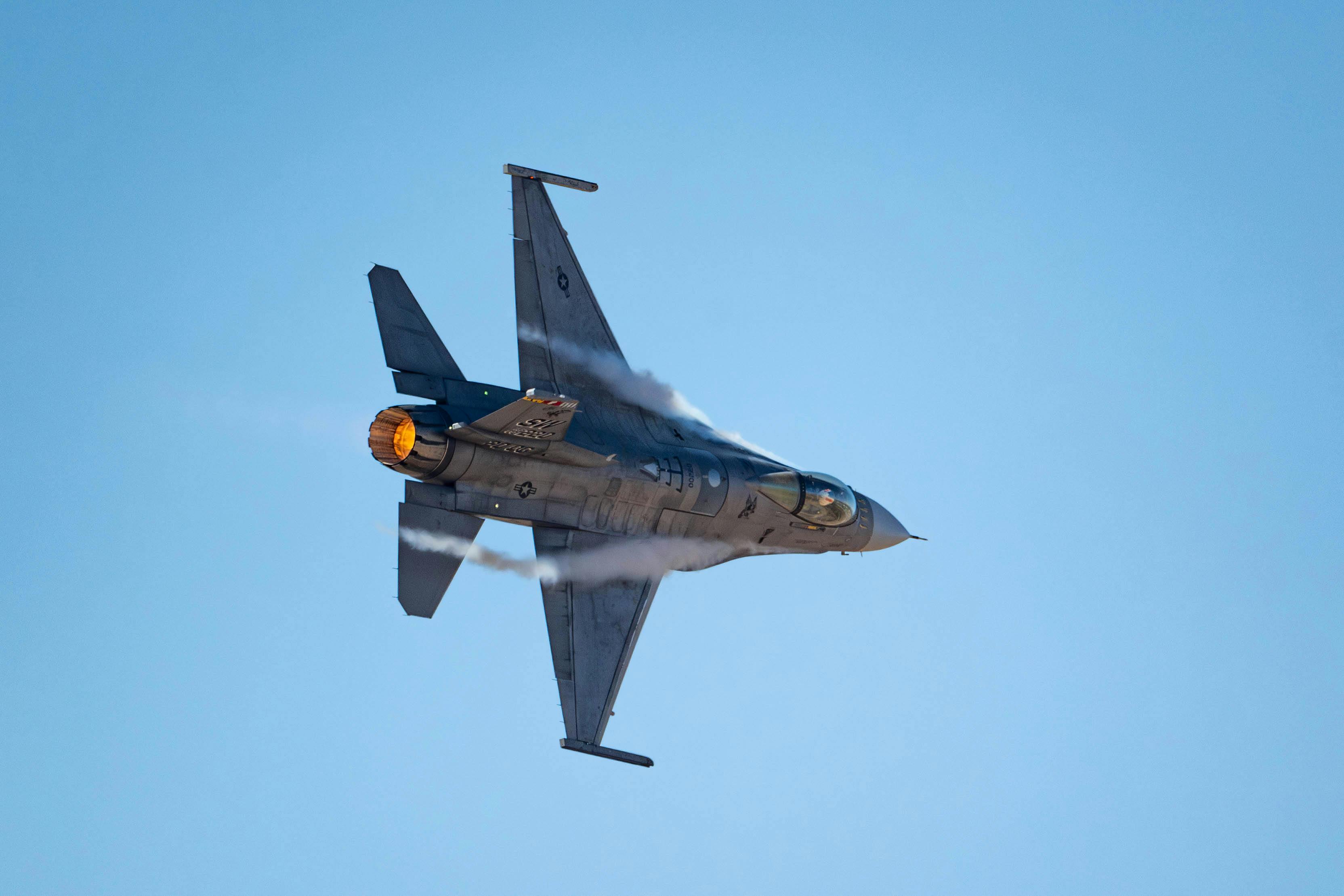 An Air Force F-16 jet fighter performs aerial maneuvers at Davis-Monthan Air Force Base, Ariz., last March to demonstrate the aircraft's proficiency in air-to-air and air-to-ground combat.