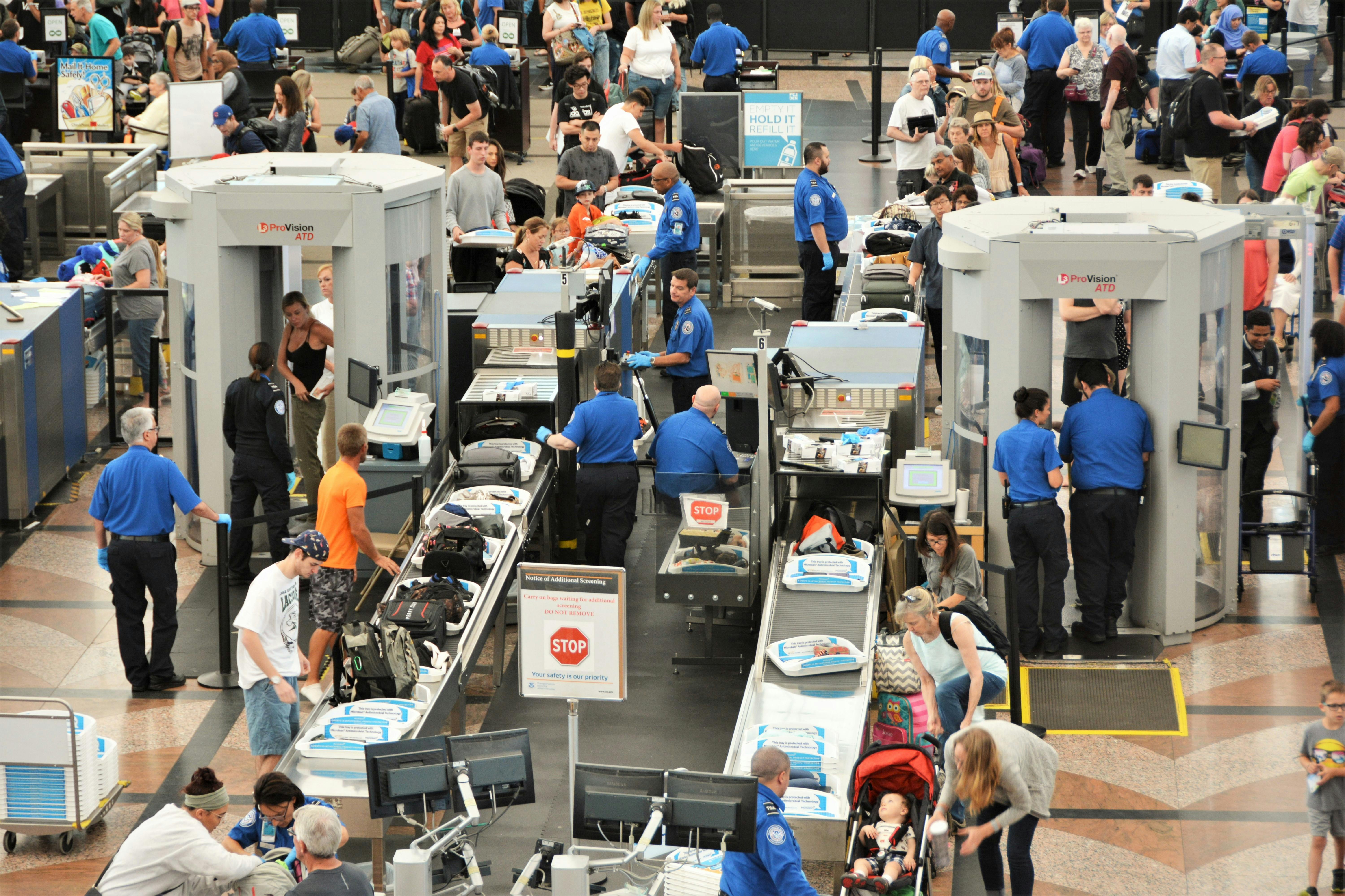 Passengers at an airport screening area