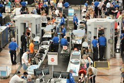 Passengers at an airport screening area Passengers at an airport screening area