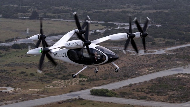 Joby test pilot James “Buddy” Denham flying a fully transitioned Joby aircraft above the company’s facilities in Marina, California. Photo: Joby Aviation.