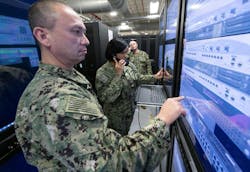 Sailors demonstrate the Common Submarine Radio Room Multipurpose Reconfigurable Training System (CSRR MRTS) for providing hands-on training to the submarine force. Sailors demonstrate the Common Submarine Radio Room Multipurpose Reconfigurable Training System (CSRR MRTS) for providing hands-on training to the submarine force.
