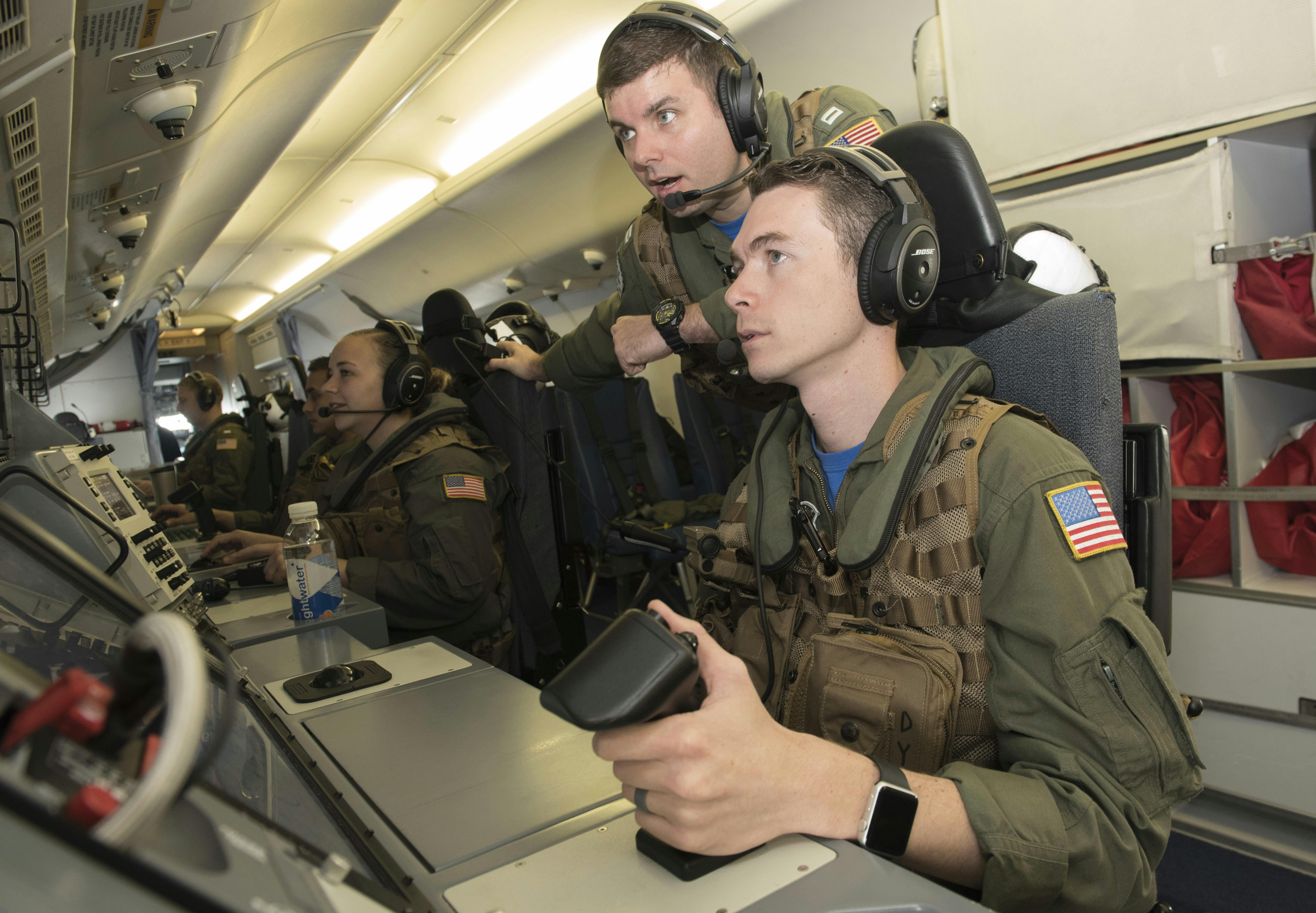 Navy operators monitor displays aboard a P-8A Poseidon maritime patrol jet, which has broad aerial anti-submarine warfare (ASW) capabilities.