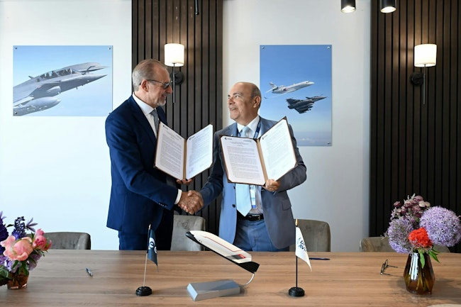 A Dassault representative shaking hands with an European Space Agency rep.