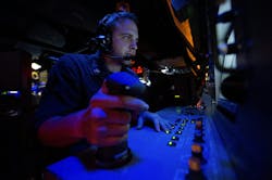 A Navy fire controlman stands watch in the combat information center aboard the guided-missile destroyer USS Arleigh Burke (DDG 51). A Navy fire controlman stands watch in the combat information center aboard the guided-missile destroyer USS Arleigh Burke (DDG 51).
