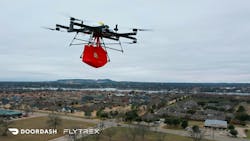 A Flytrex quad copter carrying a bag over a neighborhood A Flytrex quad copter carrying a bag over a neighborhood