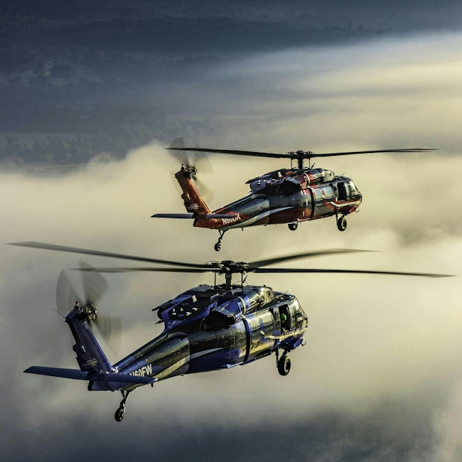 Two Black Hawk helicopters flying.