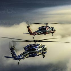 Two Black Hawk helicopters flying. Two Black Hawk helicopters flying.