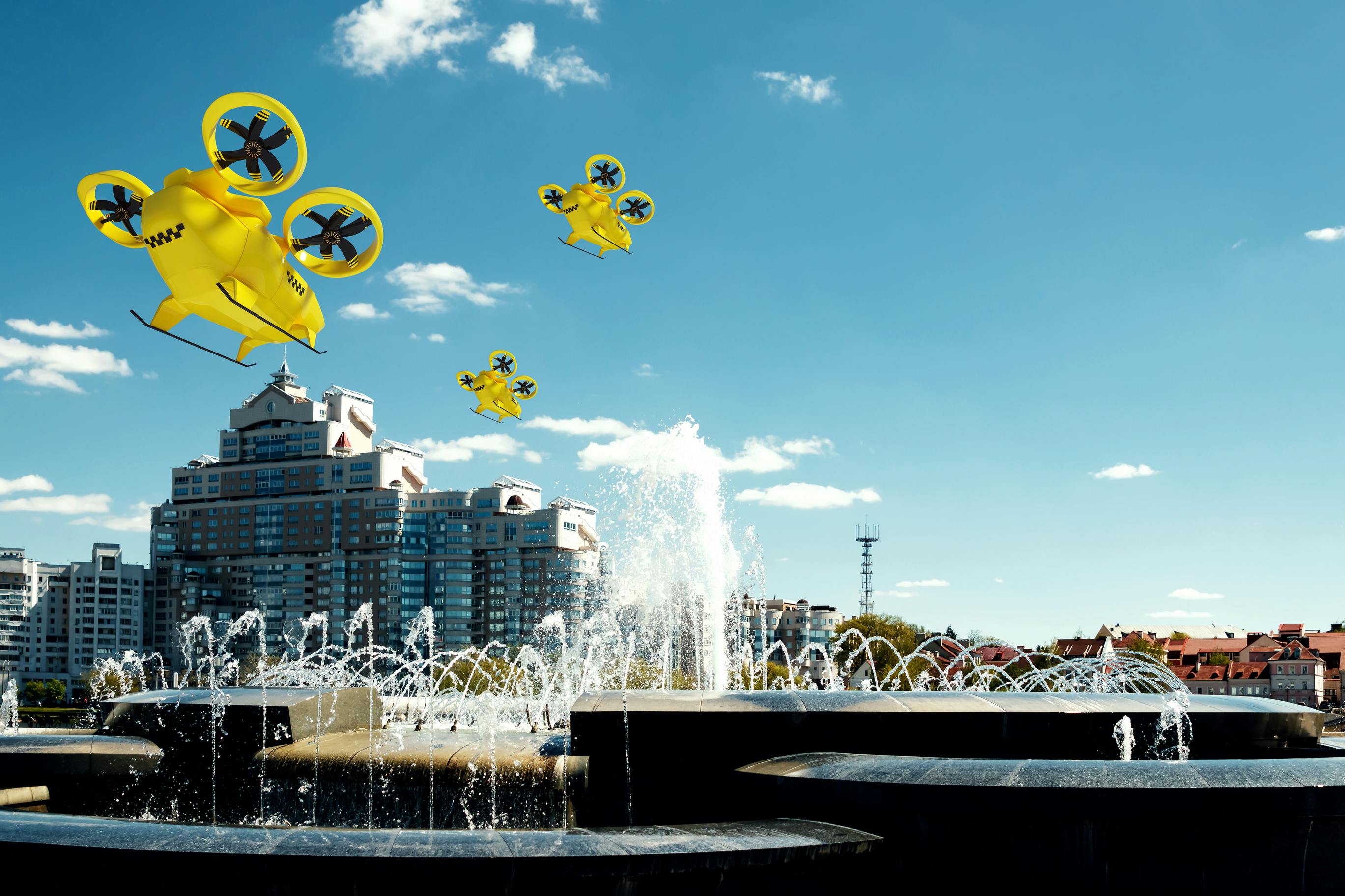 A trio of rendered air taxis fly over fountains.