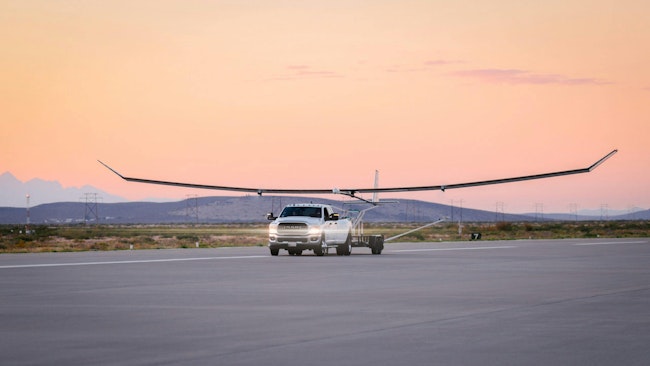 A truck pulls Swift's SULE UAV on tarmac