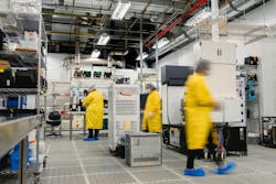 Workers in a clean room and electronics Workers in a clean room and electronics