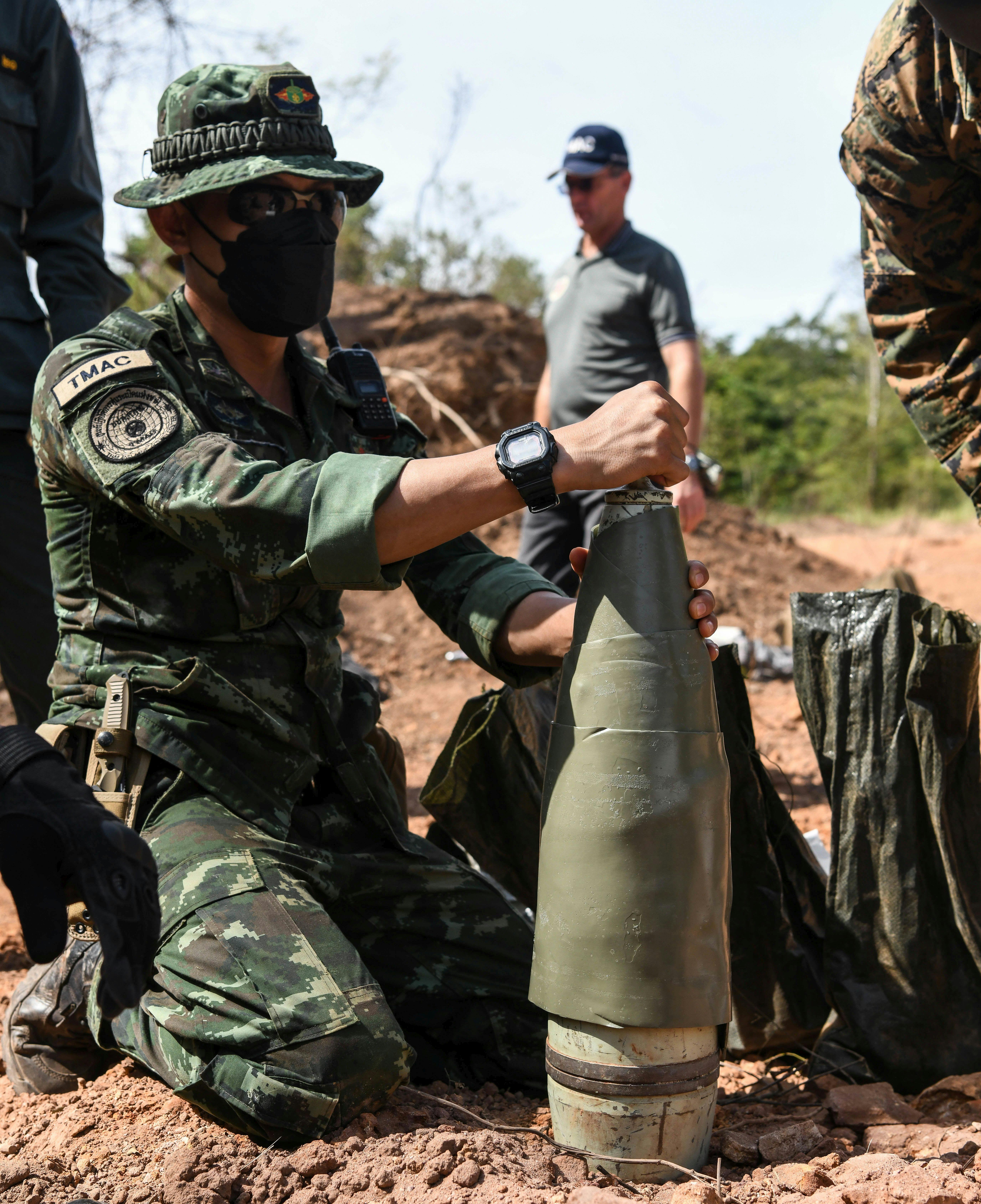 A Royal Thai Army artilleryman wraps a 155 millimeter white phosphorus artillery round with detonation cord for large scale detonation during Exercise Cobra Gold in 2021.
