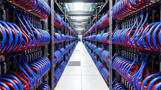 A long row of electronics running down an aisle with person at the far end.
