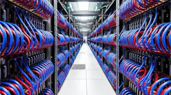 A long row of electronics running down an aisle with person at the far end.