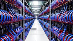 A long row of electronics running down an aisle with person at the far end. A long row of electronics running down an aisle with person at the far end.