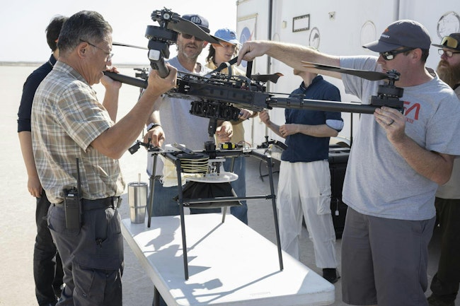 Derek Abramson, left, and Justin Link, right, attach an Alta X drone to the Enhancing Parachutes by Instrumenting the Canopy test experiment on June 4, 2025, at NASA’s Armstong Flight Research Center in Edwards, California. Abramson is NASA chief engineer at the center’s Dale Reed Subscale Flight Research Laboratory, where Link also works as a pilot for small uncrewed aircraft systems. NASA researchers are developing technology to make supersonic parachutes safer and more reliable for delivering science instruments and payloads to Mars. NASA/Christopher LC Clark image.