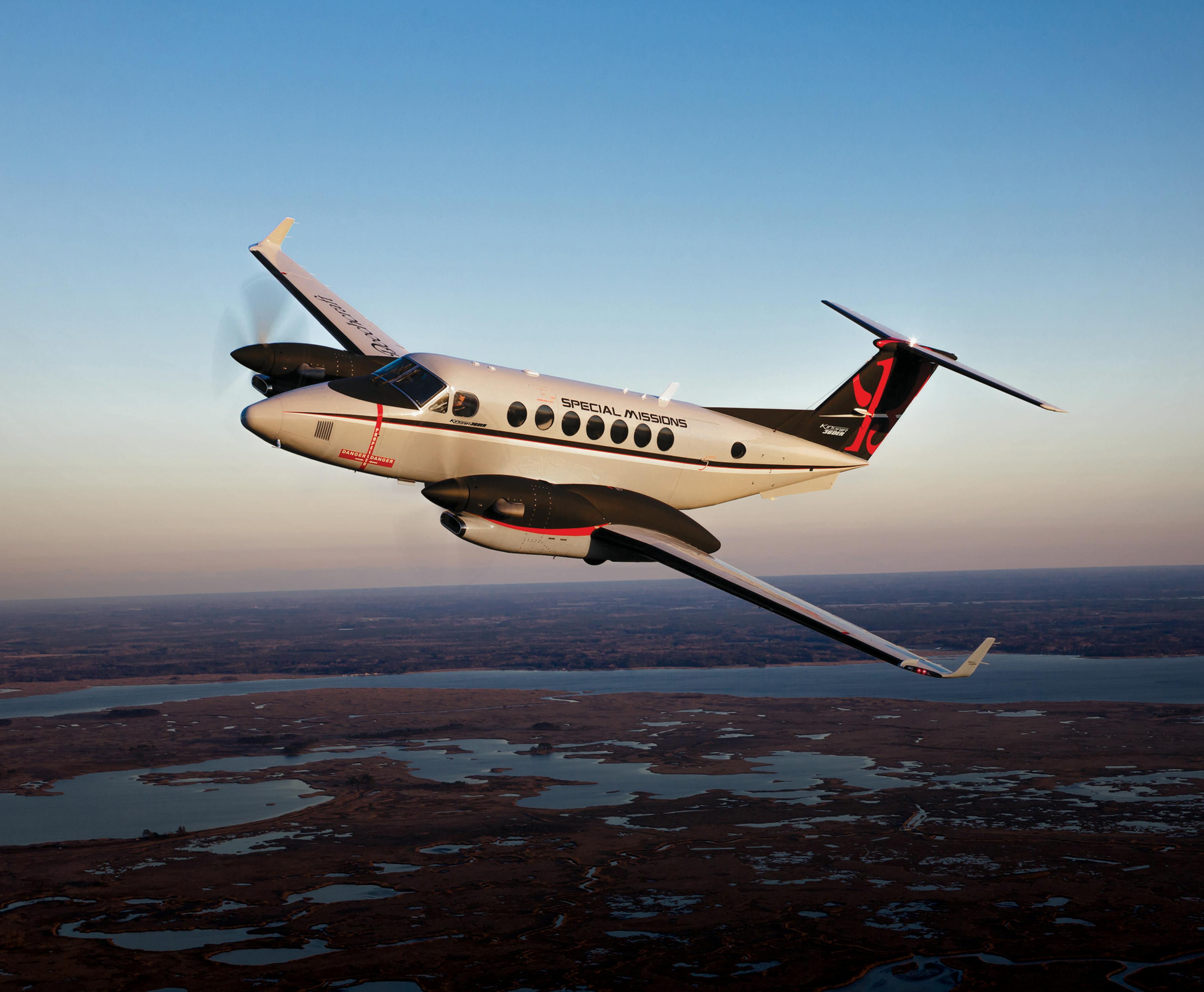 The Beechcraft 360ER in flight over a landscape.