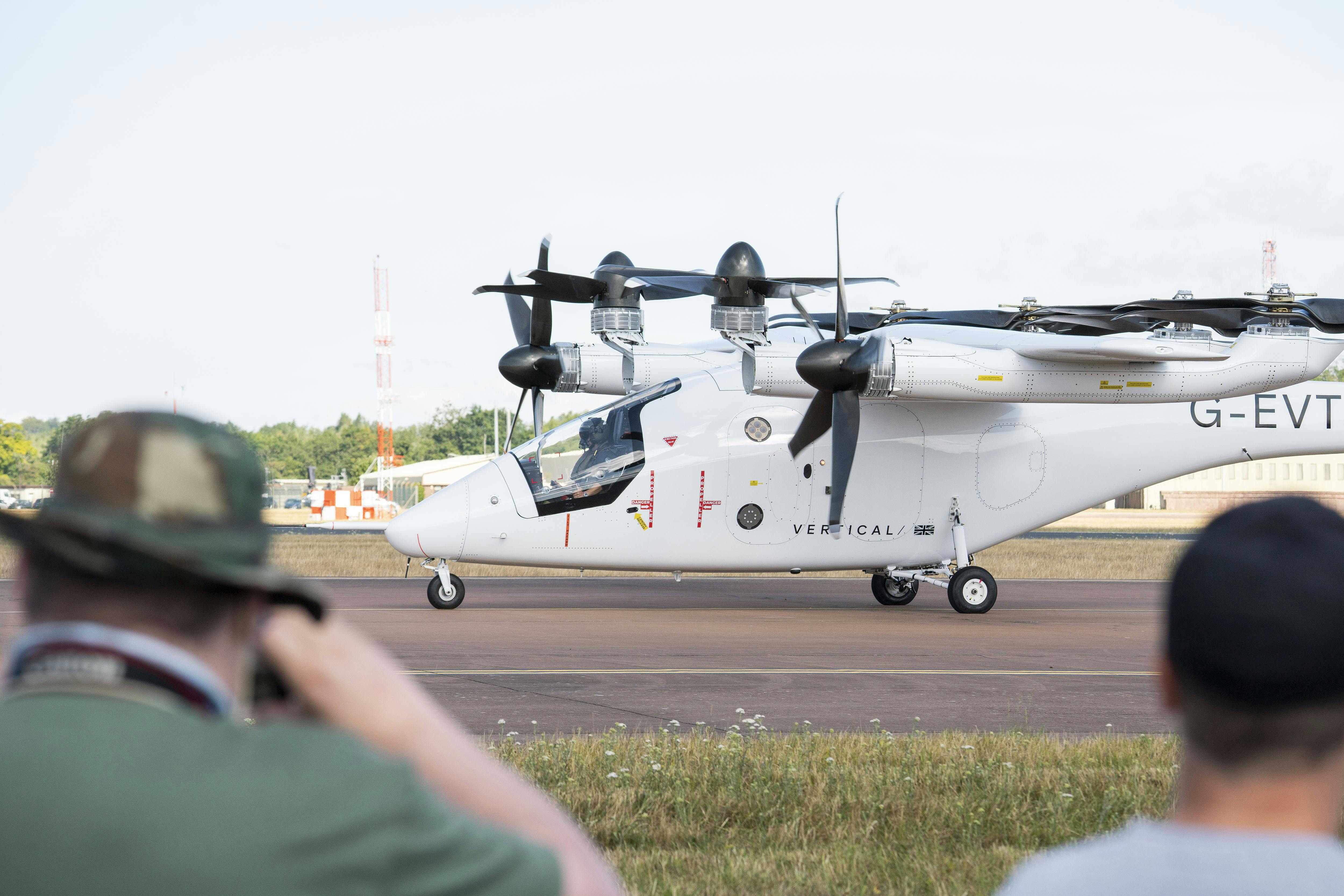 Spectators take pictures of the VX4 prototype shortly after landing at RAF Fairford in what Vertical says is the world's first airport-to-airport piloted flight a full-scale, winged tilt-rotor eVTOL designed for commercial service when it flew in July 2025.