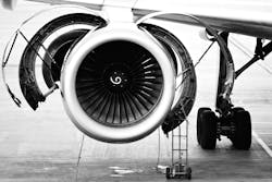 A black and white photo of a jet engine undergoing maintenance A black and white photo of a jet engine undergoing maintenance