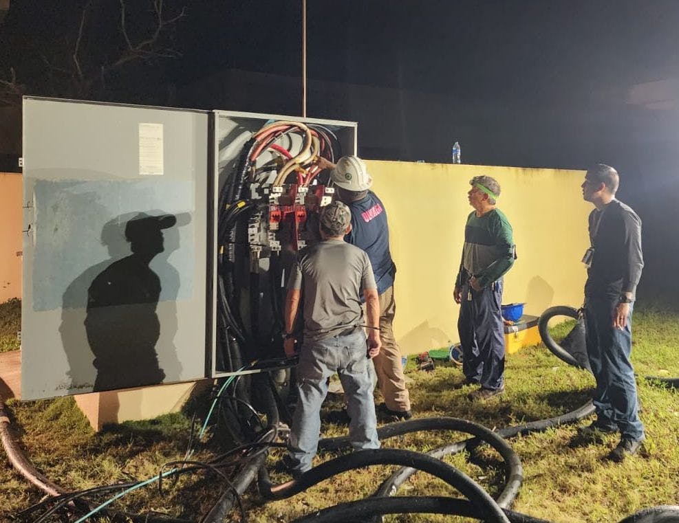 Naval personnel work to repair damage and to distribute power to commands and residents on Naval Base Guam last June after Typhoon Mawar passed over the island.