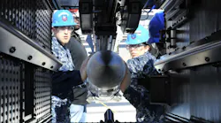 Sailors aboard the aircraft carrier USS Gerald R. Ford (CVN 78) practice loading an inert-dummy RIM-162 Evolved SeaSparrow Missile into a launcher.