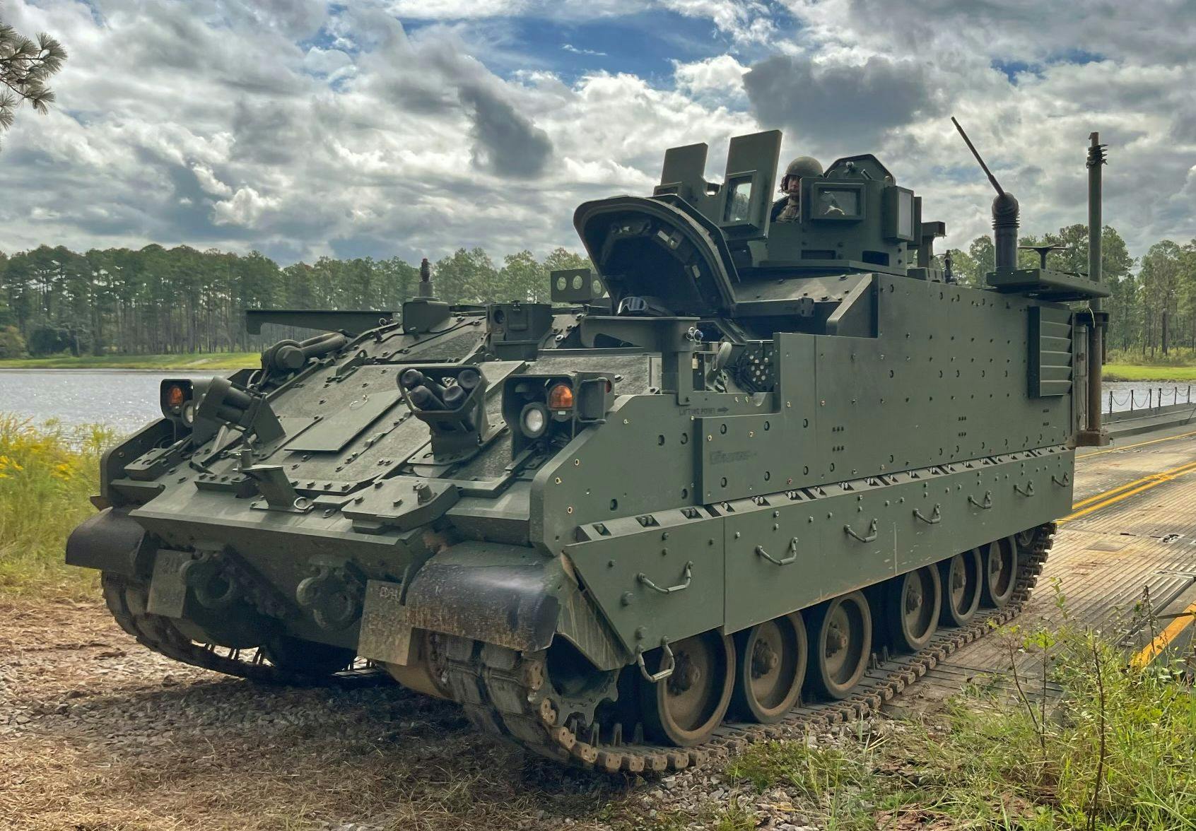 A 3rd Infantry Division Armored Multi-Purpose Vehicle drives off of a barge during a wet-gap crossing exercise on Fort Stewart, Ga., in 2021.